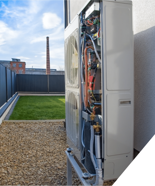 A modern heat pump unit installed outside a home, efficiently transferring heat for heating and cooling purposes