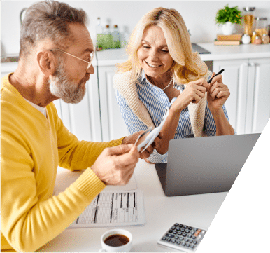 Two elderly couples reviewing their energy bill together, discussing costs and savings in a cozy living room setting