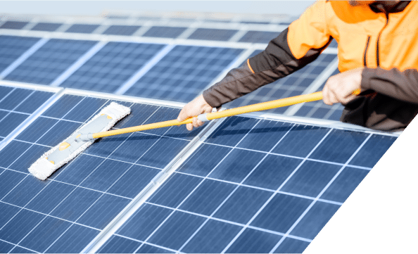 man using a broom to clean solar panels, ensuring optimal performance and efficiency in solar energy collection