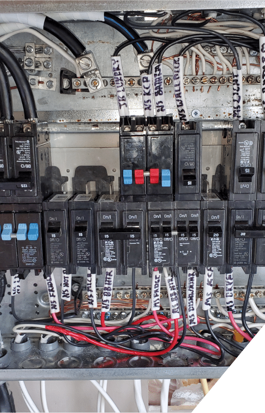 A close-up view of a panel board featuring multiple circuit breakers, showcasing their arrangement and labeling for electrical control